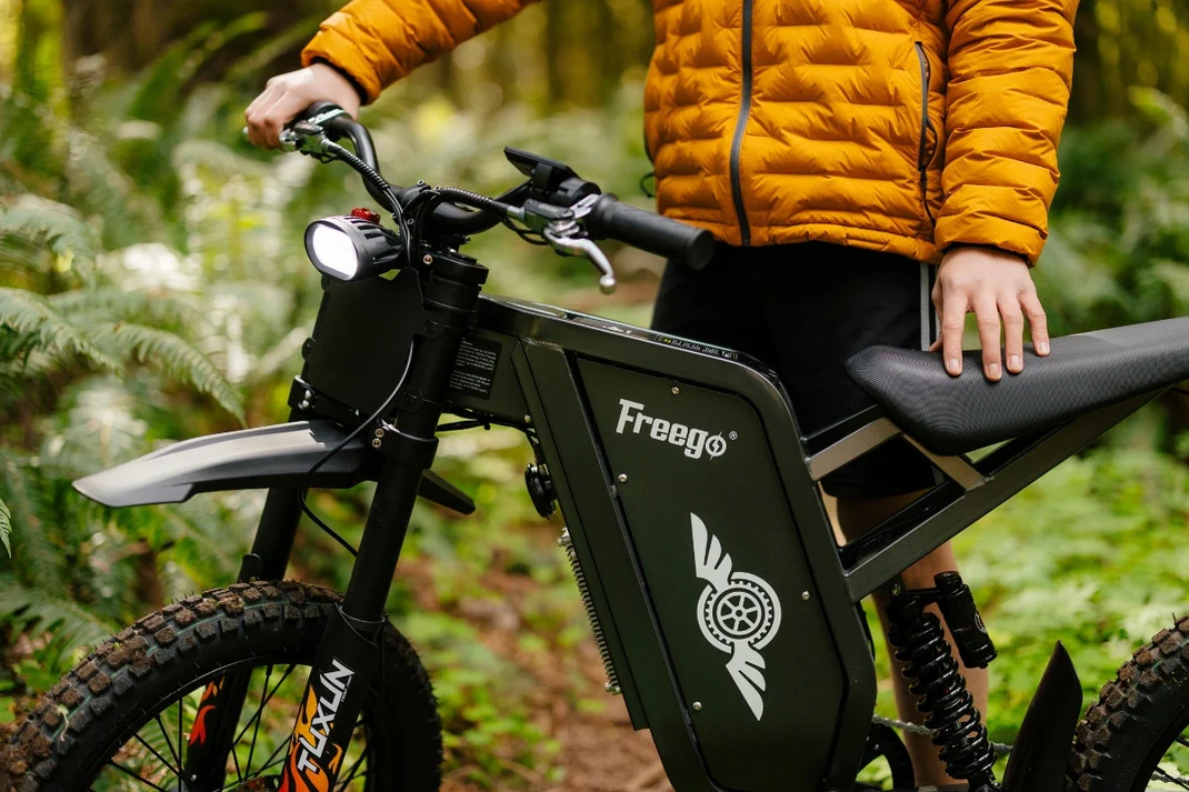 Person sitting on a Freego x1 in a forest setting