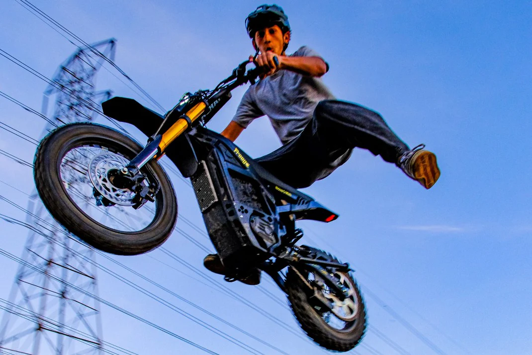 A rider soaring through the air on the Freego Nova 5 Mini