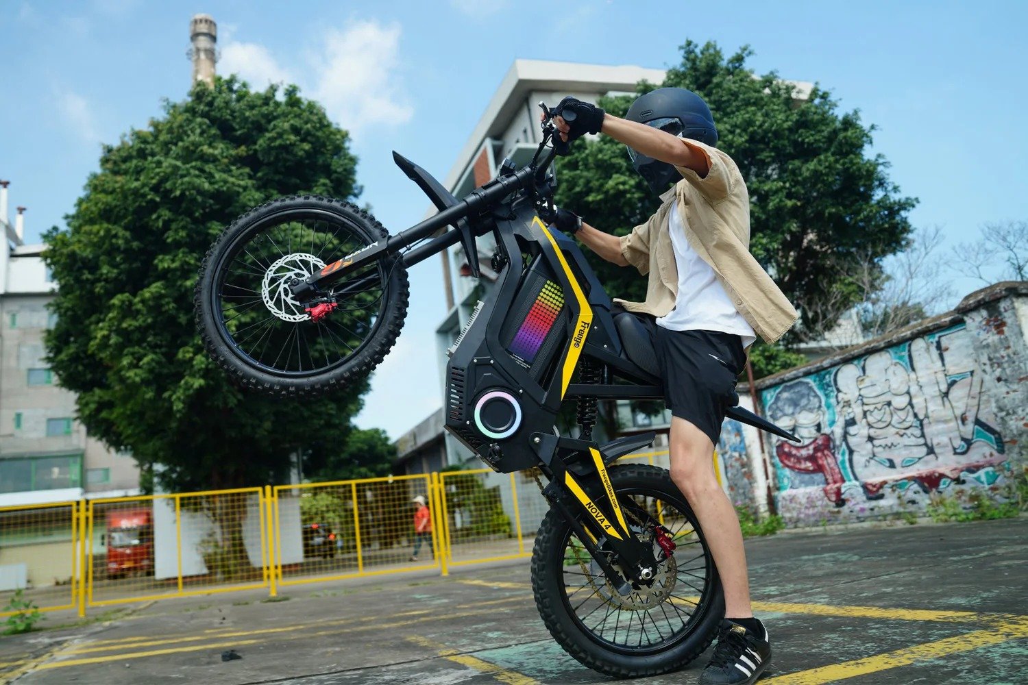 Rider doing wheelie on Freego Nova4 electric dirt bike outdoors